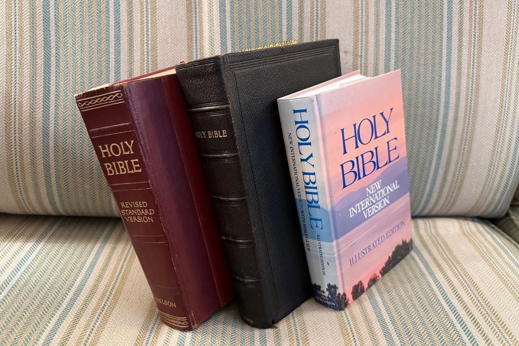 Three bibles sit on a couch.