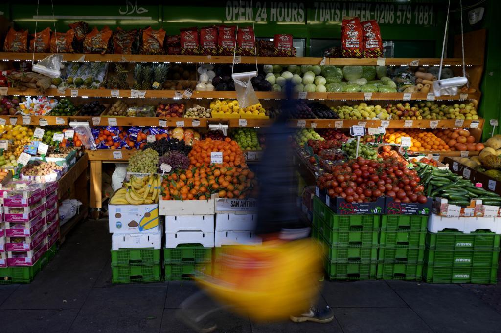 A customer passes a fruit supermarket.