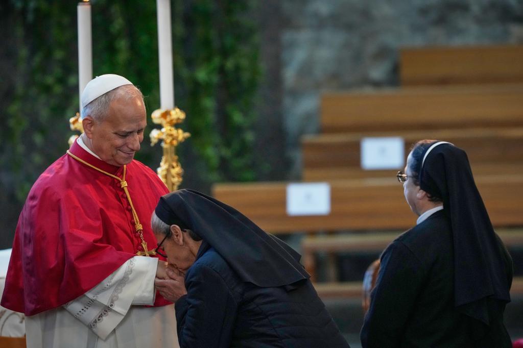 A nun kisses Pope Leo XIV's.