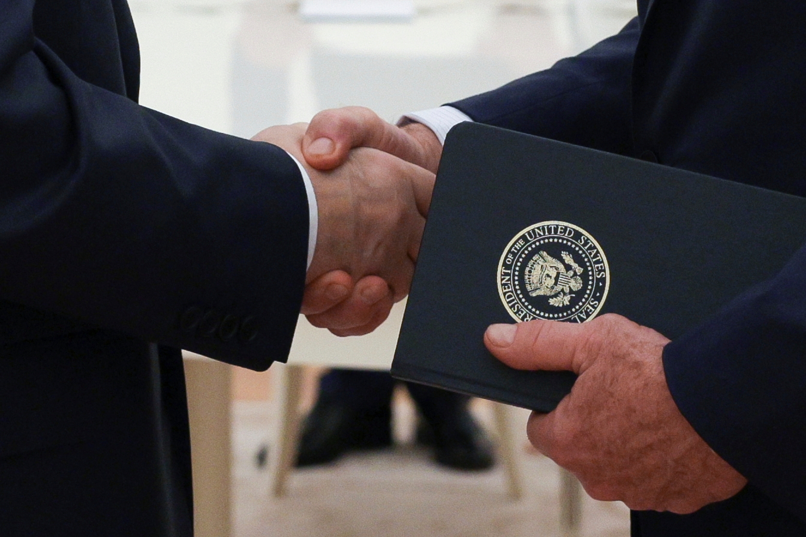 Russian President Vladimir Putin and U.S. President Donald Trump's special envoy Steve Witkoff shakes hands during their meeting.