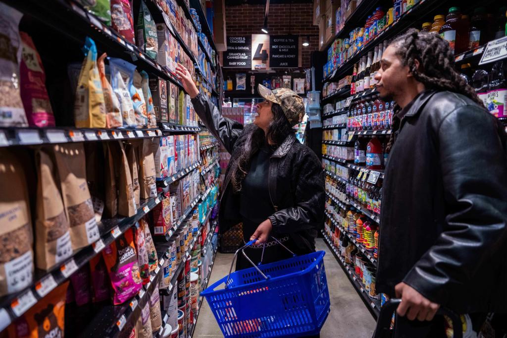 Kashish Ali and Elliott McKnight grocery shop before filling a One Love Community Fridge