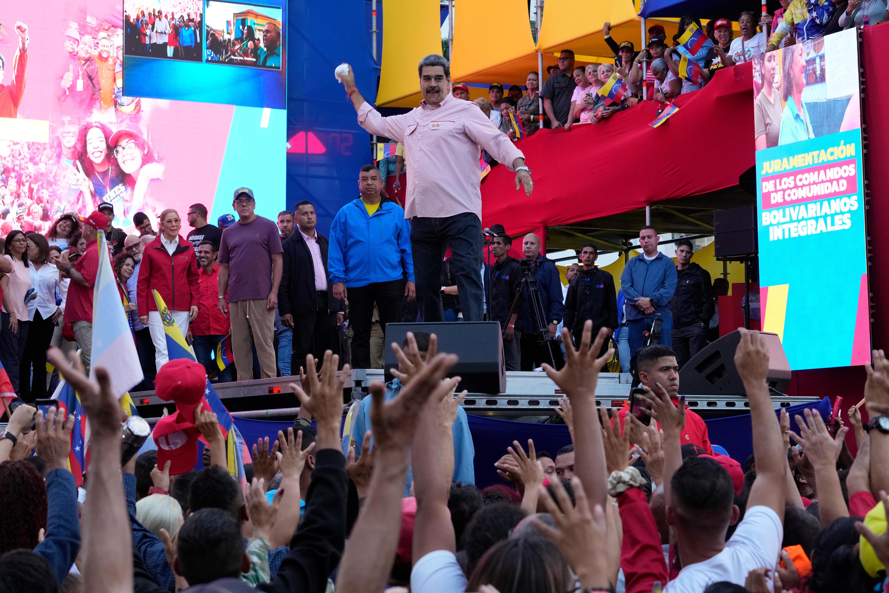 Venezuelan President Maduro winds up to throw his handkerchief to supporters.