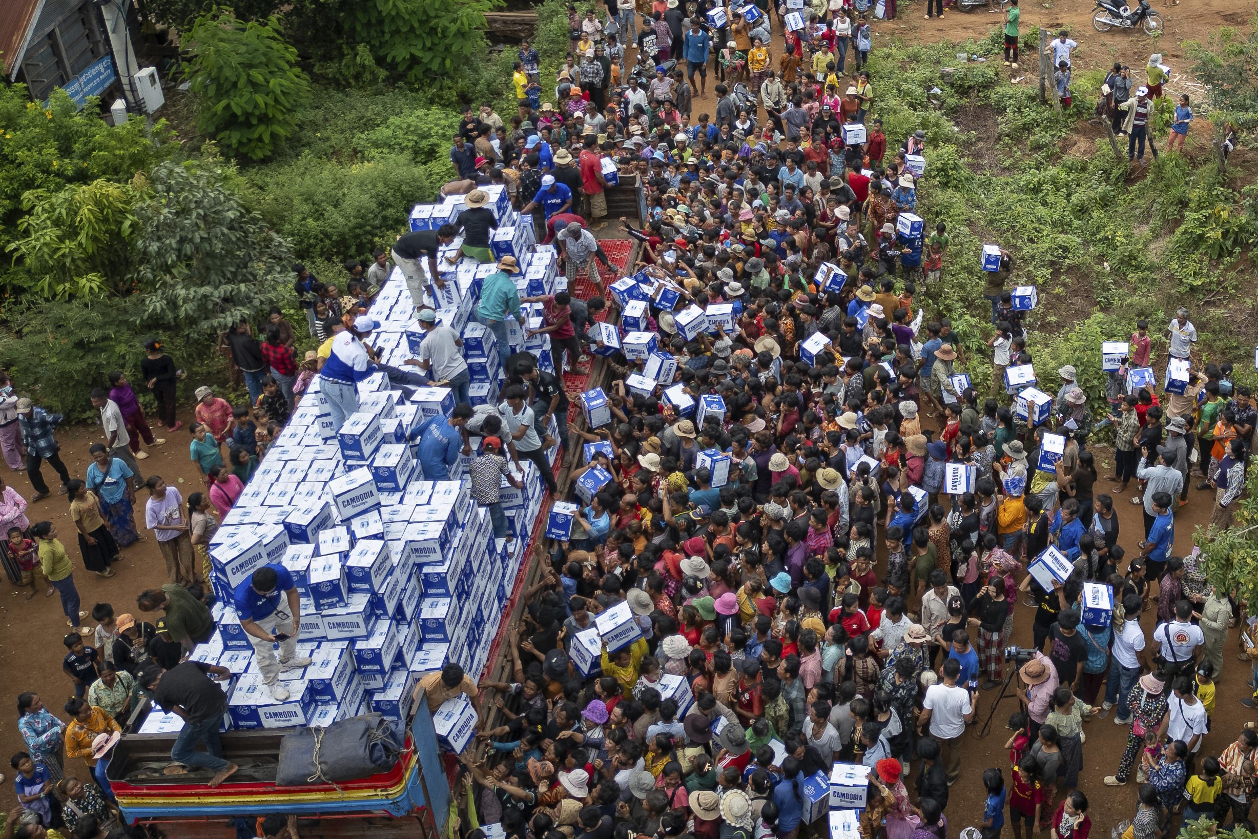 Displaced Cambodians receive water at the Battkhao Resettlement Camp.