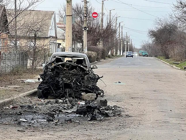 A burnt car on a street in Sloviansk.