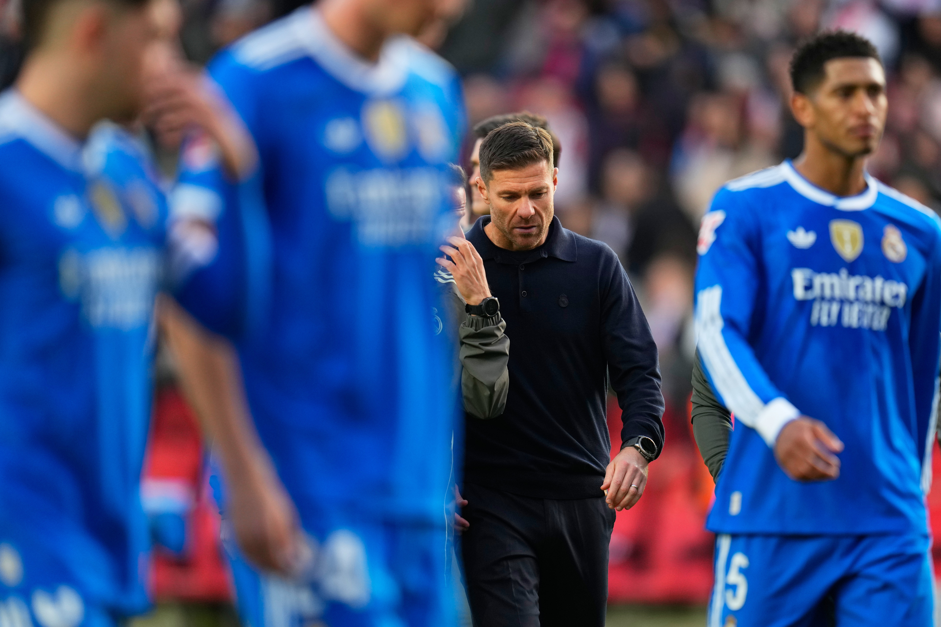 Real Madrid's head coach Xabi Alonso walks with the players.