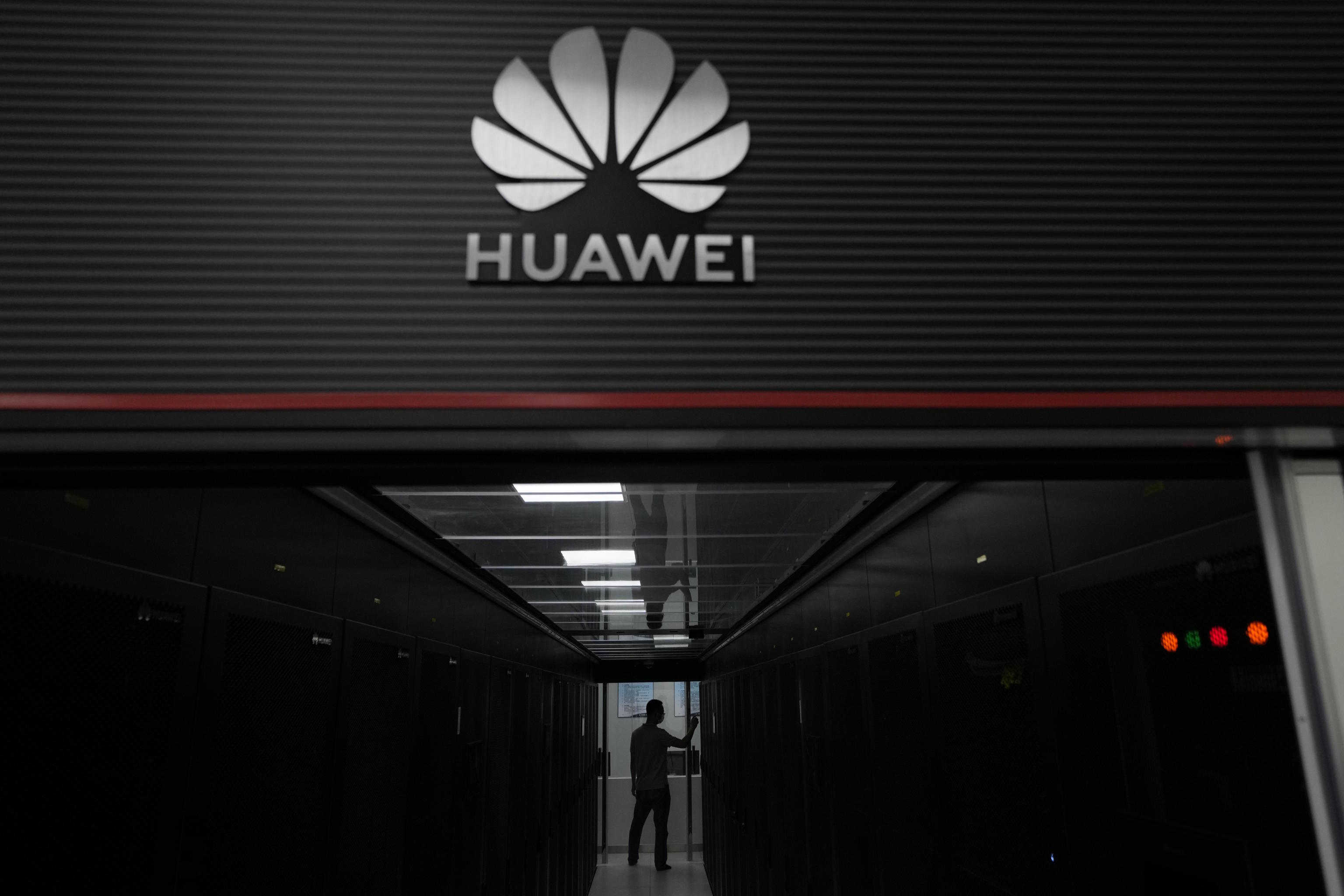 A technician stands at the entrance to a Huawei 5G data server in Guangzhou.