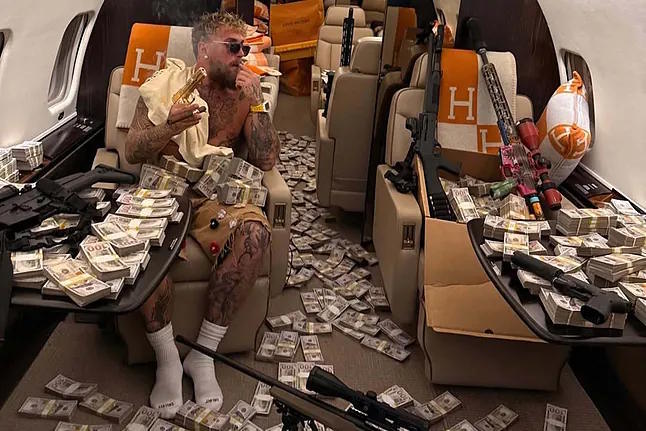 Paul, in his private jet surrounded by part of his fight earnings.