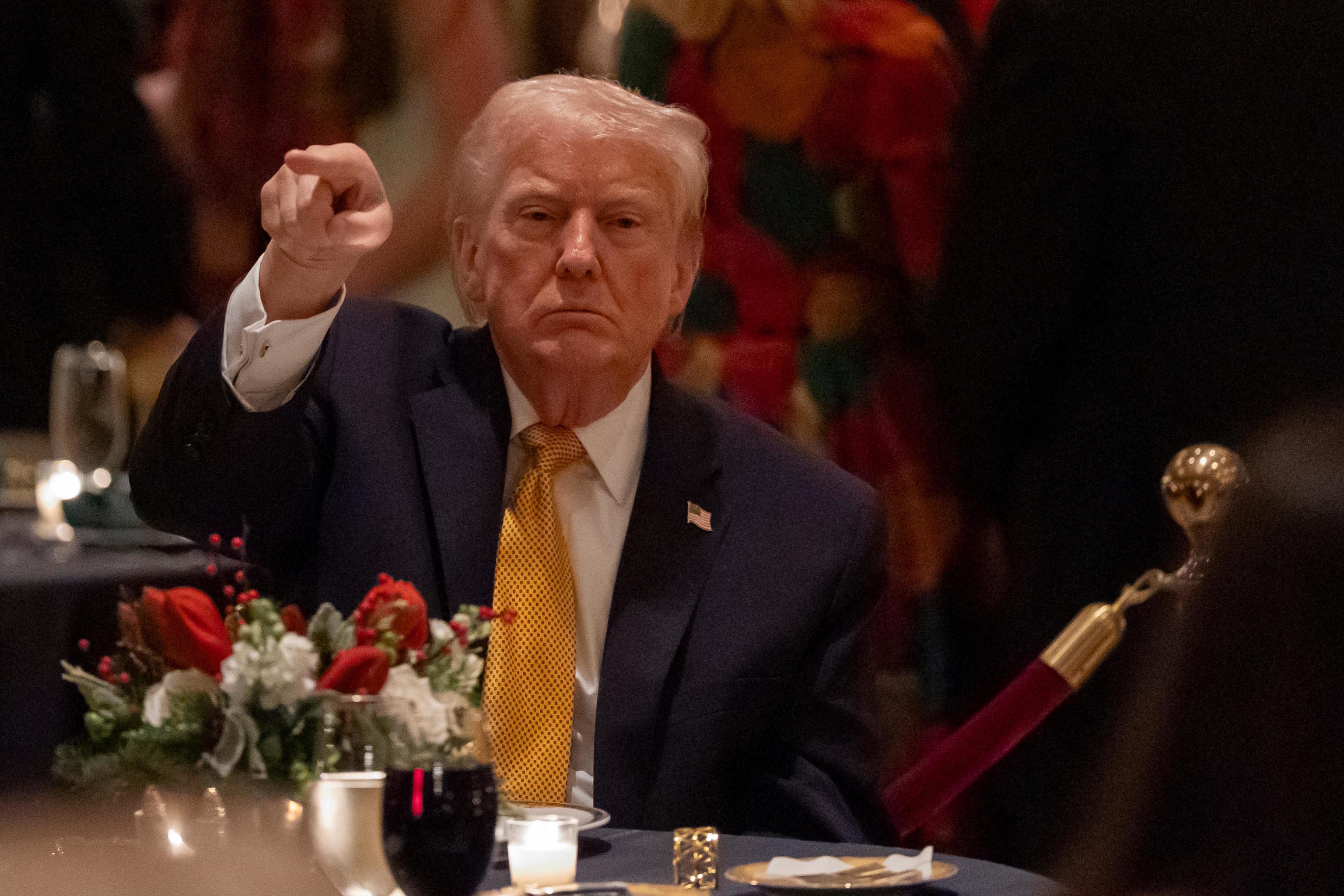 President Donald Trump gestures at Christmas Eve dinner.