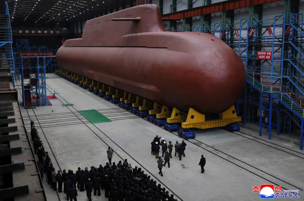 Leader Kim Jong Un inspects a nuclear-powered submarine under construction at an undisclosed location in North Korea.