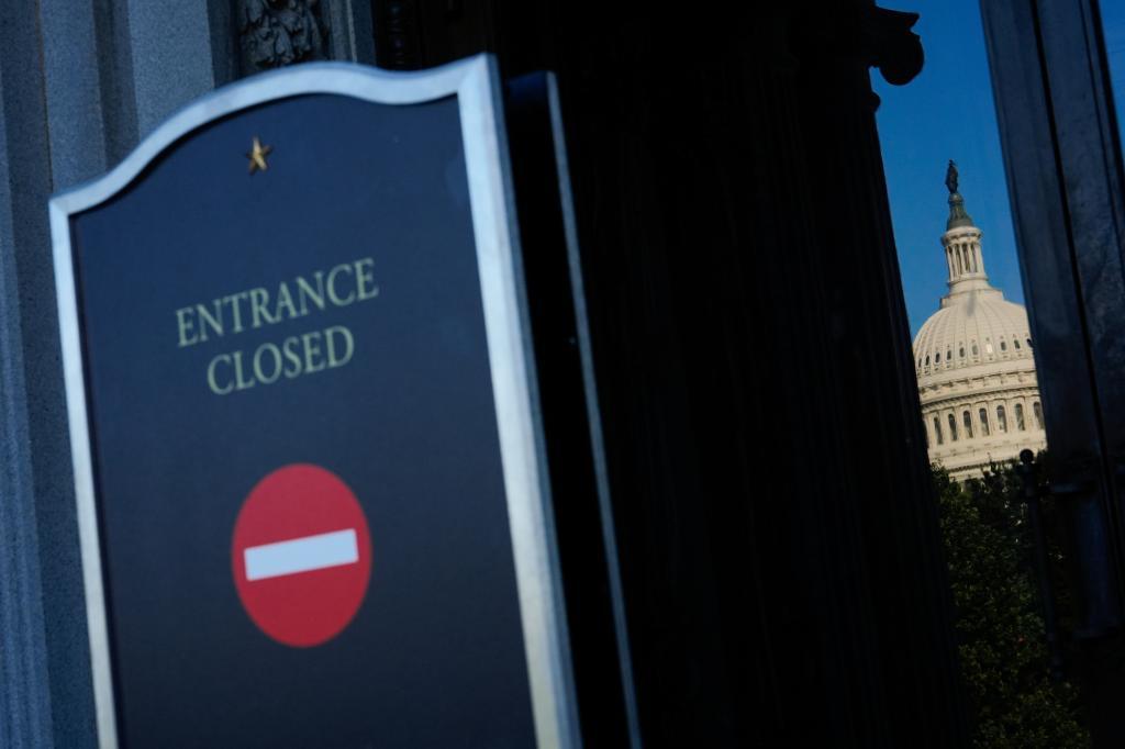 The U.S. Capitol is reflected in the doors of the Library of Congress
