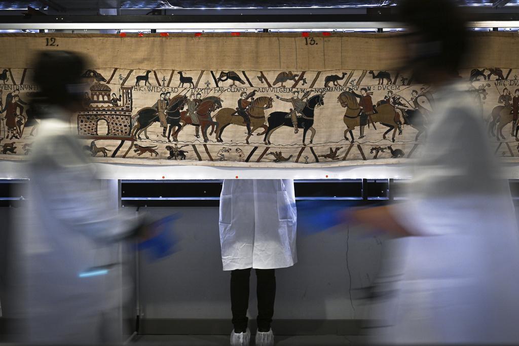 Workers and volunteers prepare to pack the Bayeux tapestry to transfer to the British Museum, at the Bayeux Tapestry Museum