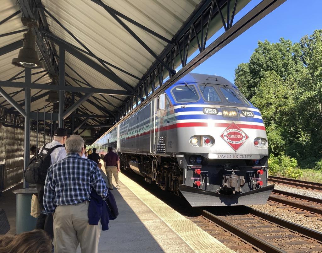 Commuters wait to board an arriving Virginia Railway Express commuter train