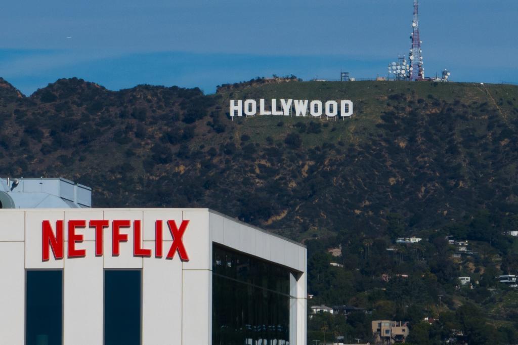 A Netflix sign is displayed atop a building in Los Angeles