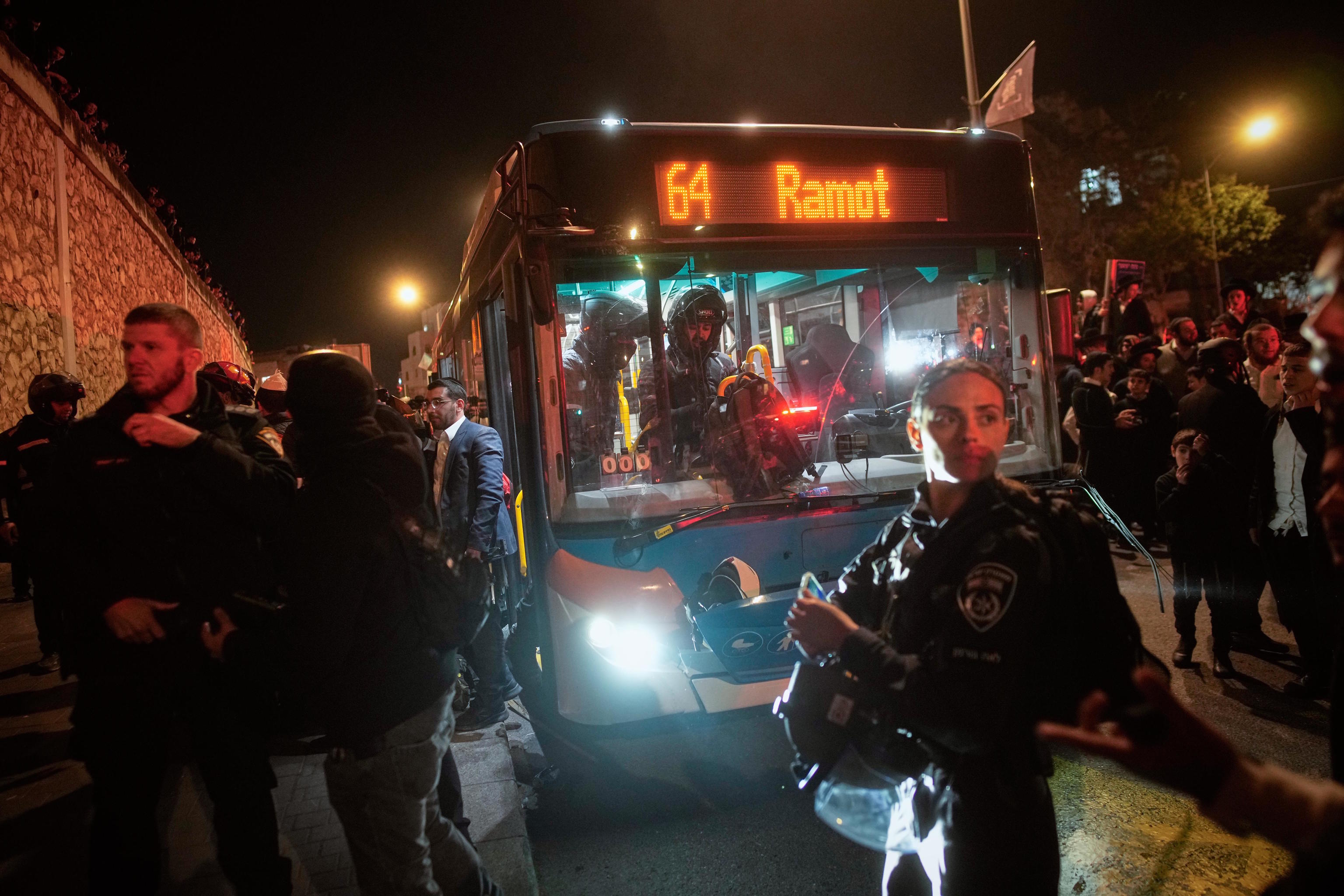 Israeli police inspect a bus after protests in Jerusalem.