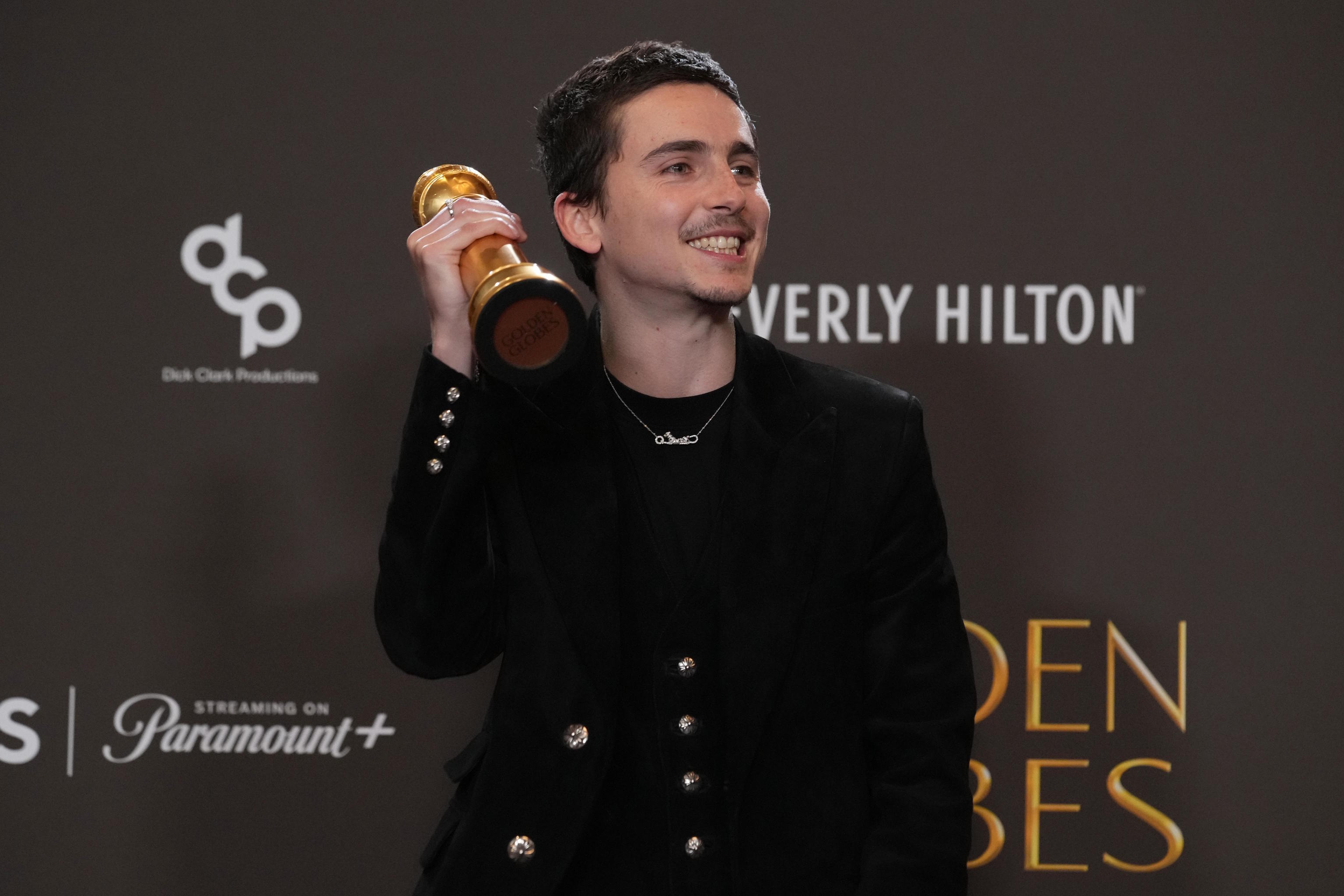 T. Chalamet poses in the press room with the award for best performance.