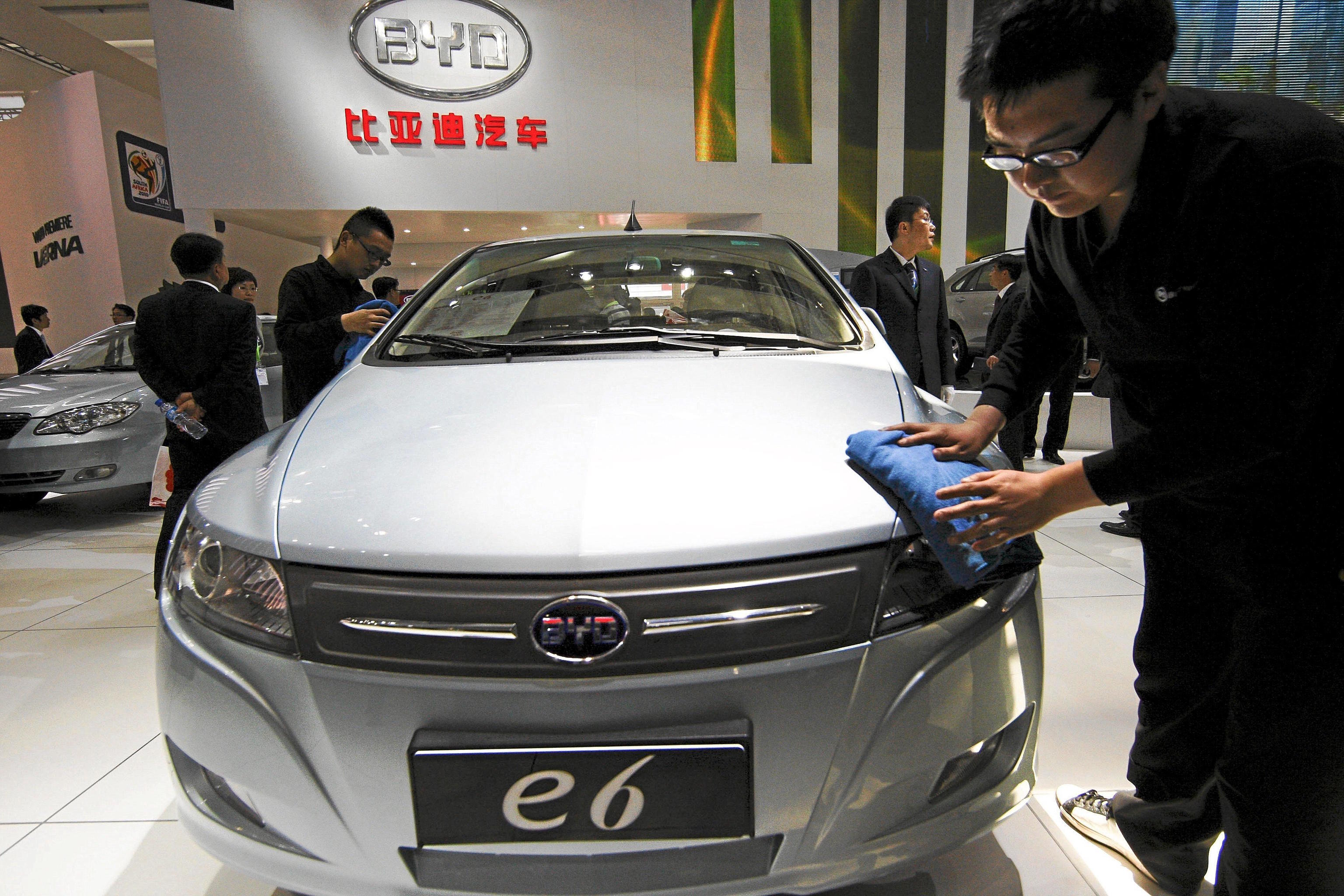 A worker cleans an all-electric BYD.