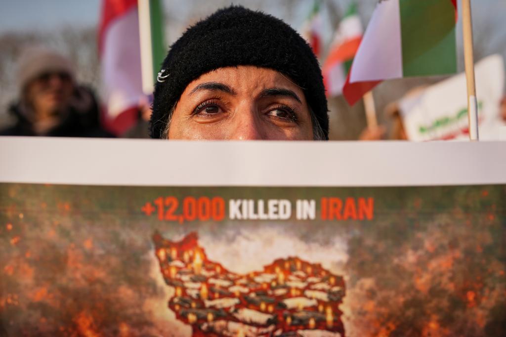 A woman cries as members of the Iranian community stage a rally in support of anti-government protests in Iran