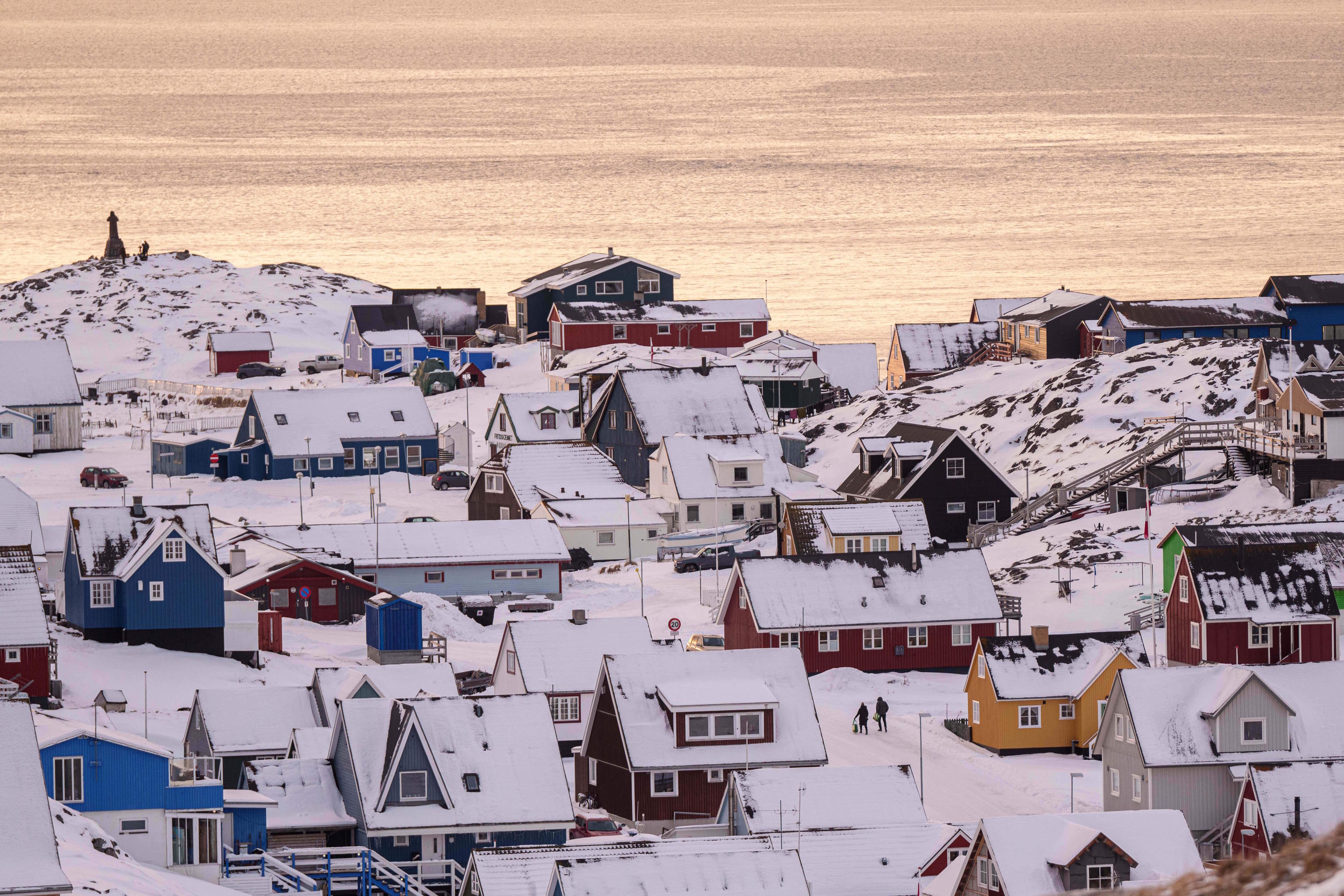 People walk on a street in Nuuk, Greenland.