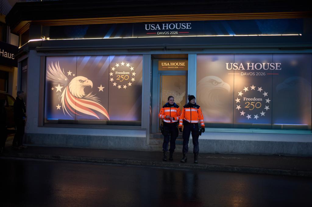 Police officers guard in front of a branch office of the USA House