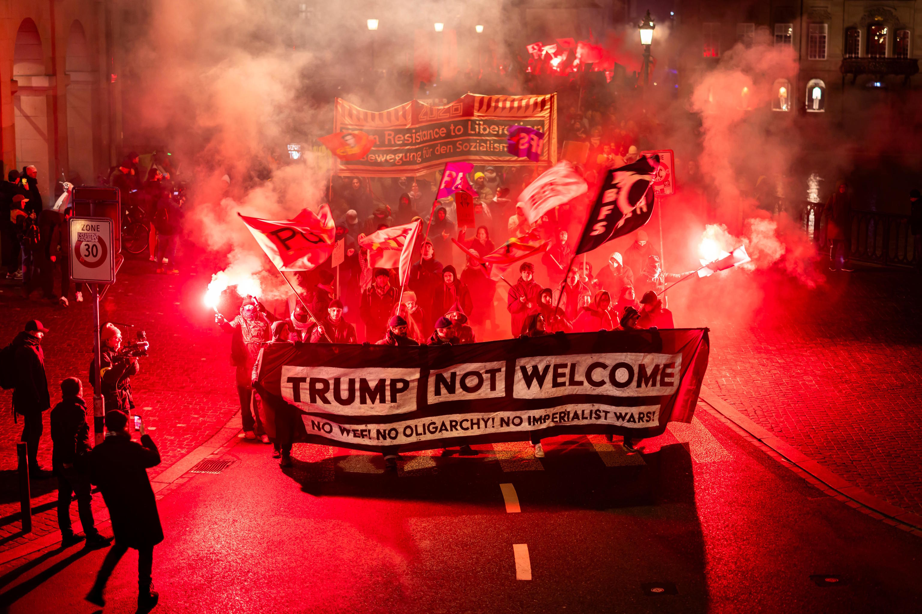 Protesters hold a banner reading "Trump not welcome" during a rally in Davos.