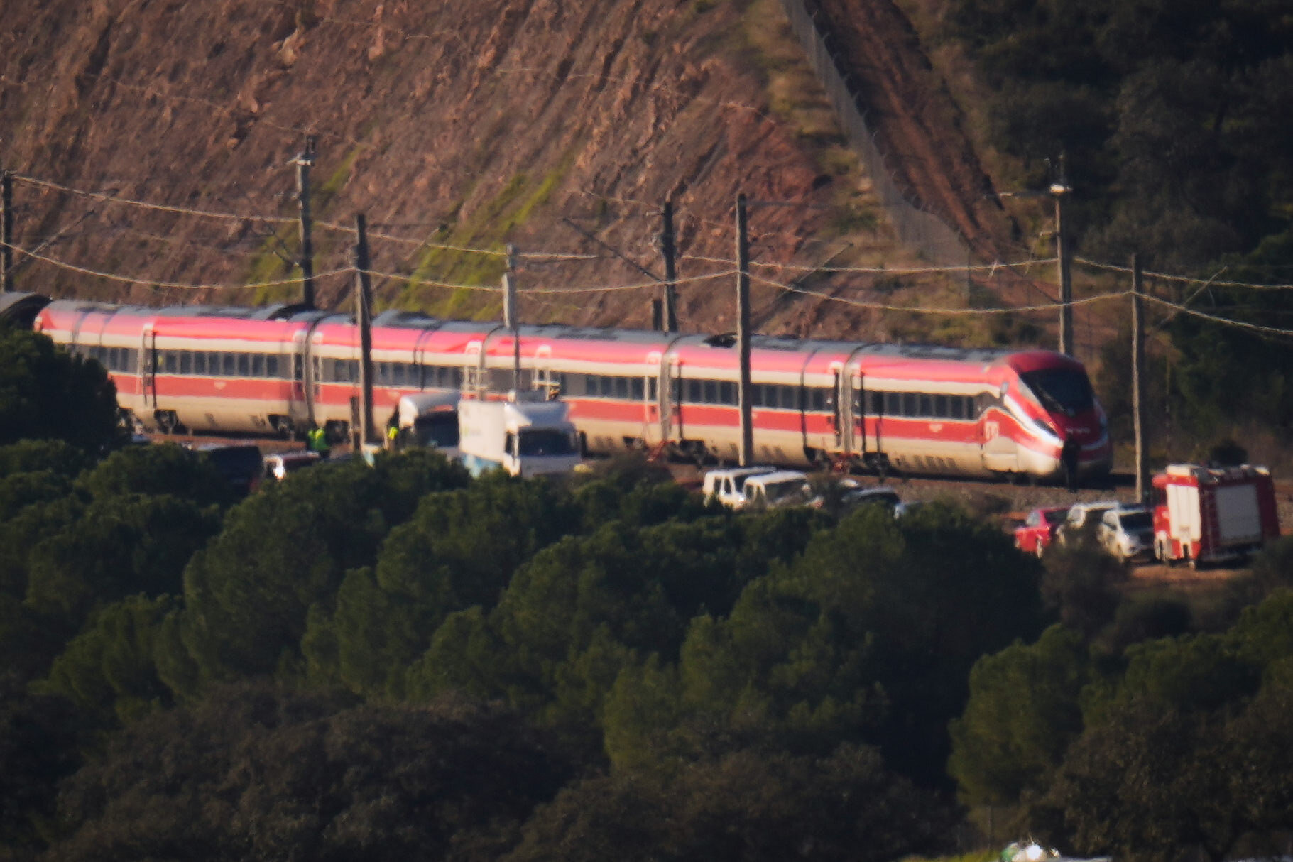 Emergency crews work alongside one of the trains involved in a train collision, in Adamuz, Spain.