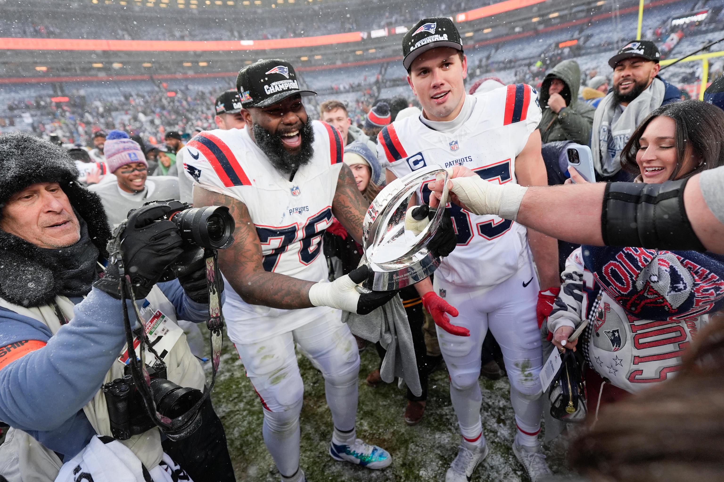 Morgan Moses and Hunter Henry of the Patriots celebrate after winning.