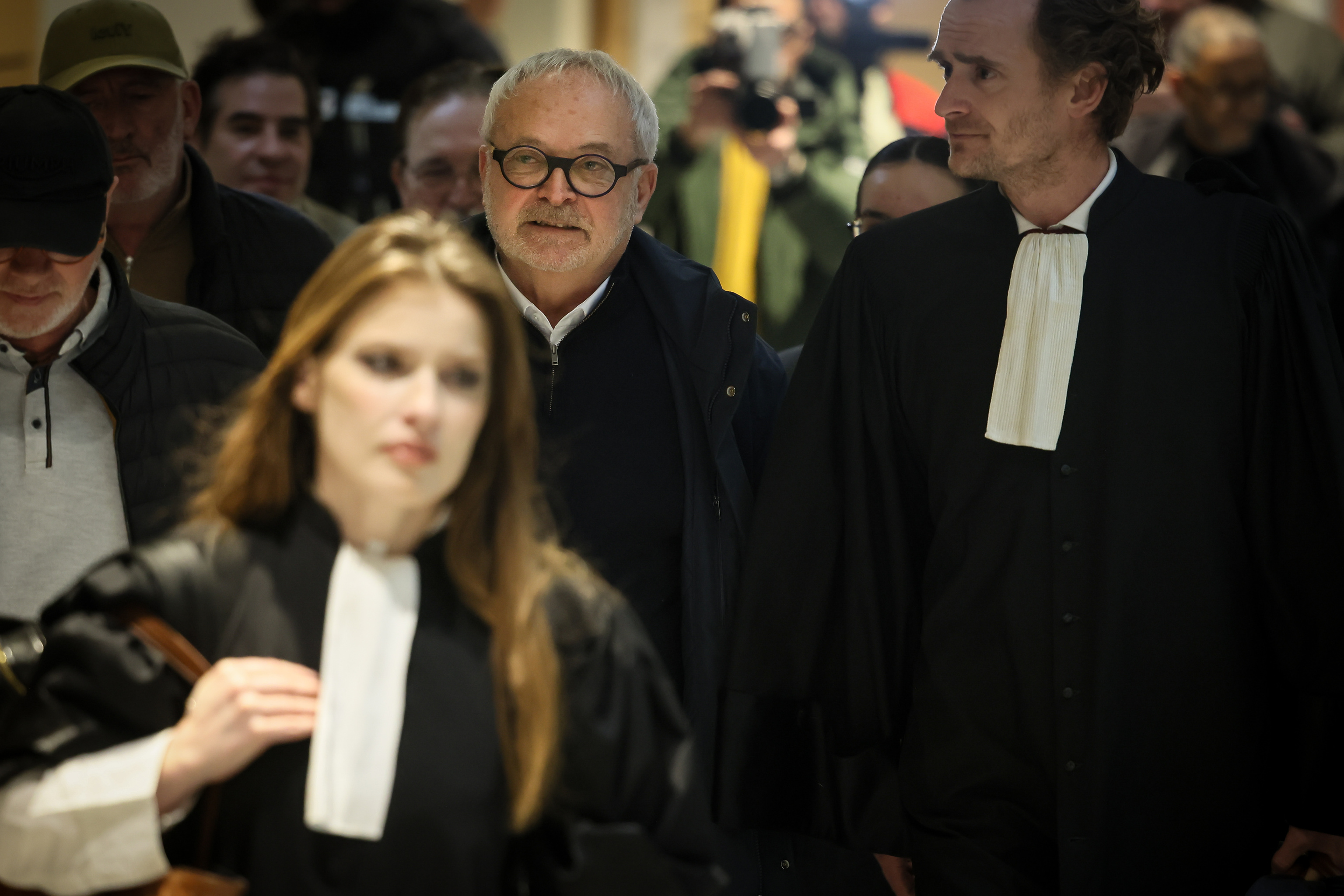 French former senator Joel Guerriau, center, and his lawyers Marie Roumiantseva, left.