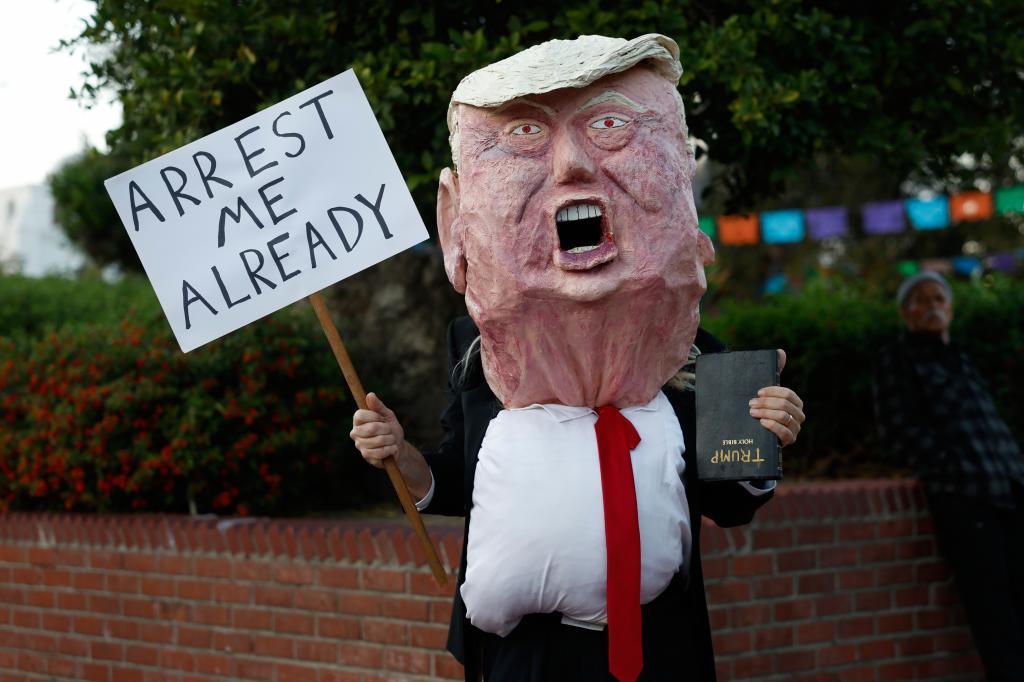 A demonstrator dressed as Donald Trump.