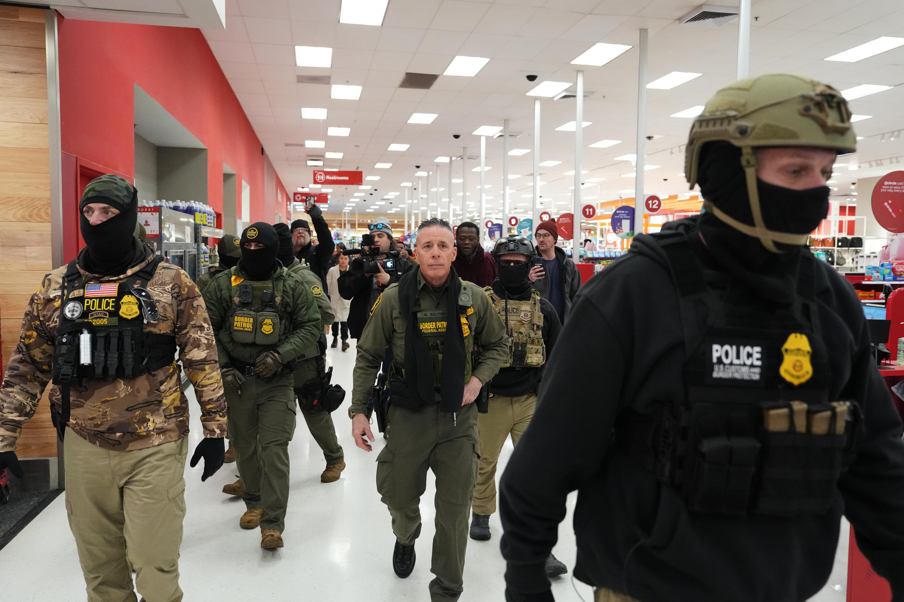 U.S. Border Patrol Cmdr. Gregory Bovino walks through a Target store.