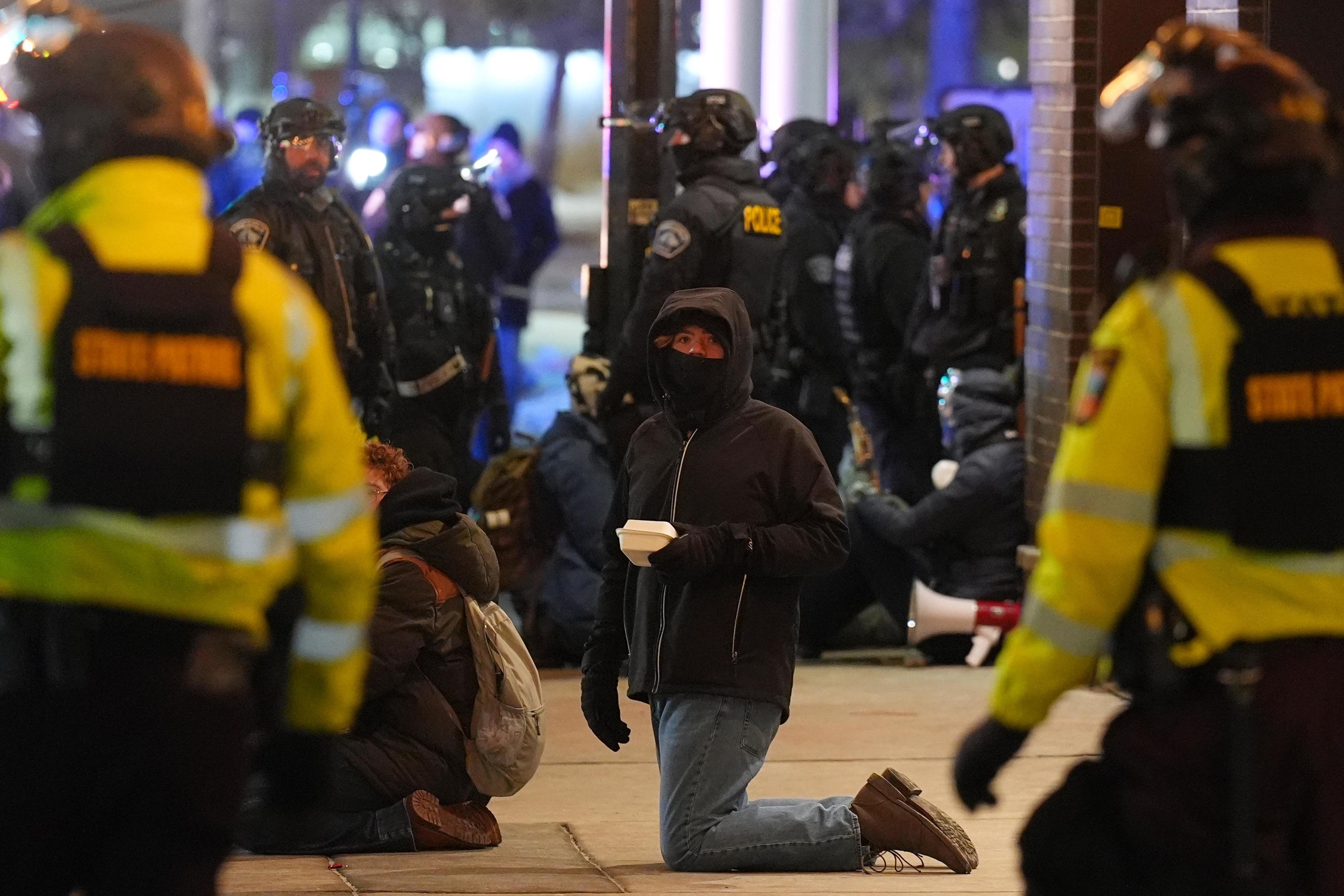 Protesters sit on the ground during a noise demonstration.