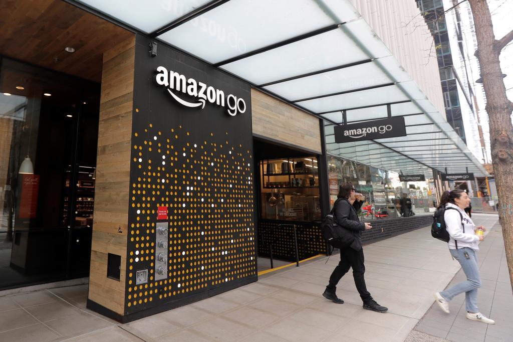 People walk out of an Amazon Go store in Seattle