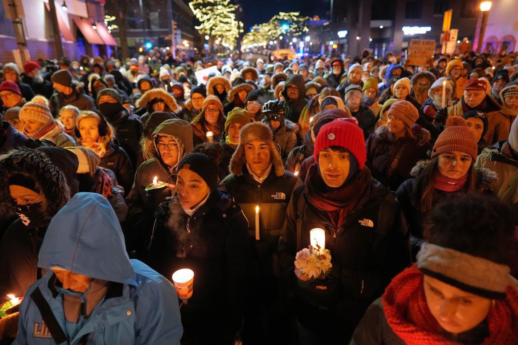 People gather during a vigil where Alex Pretti was shot and killed.