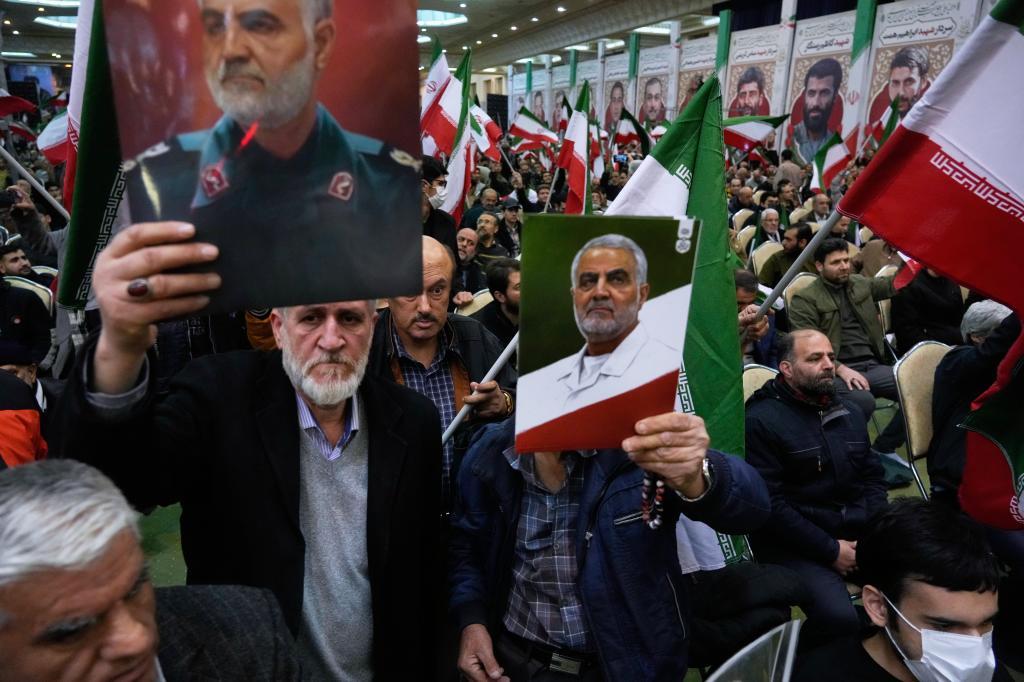 Two men hold up posters of the late commander of Iran's Revolutionary Guard expeditionary Quds Force, Gen. Qassem Soleimani