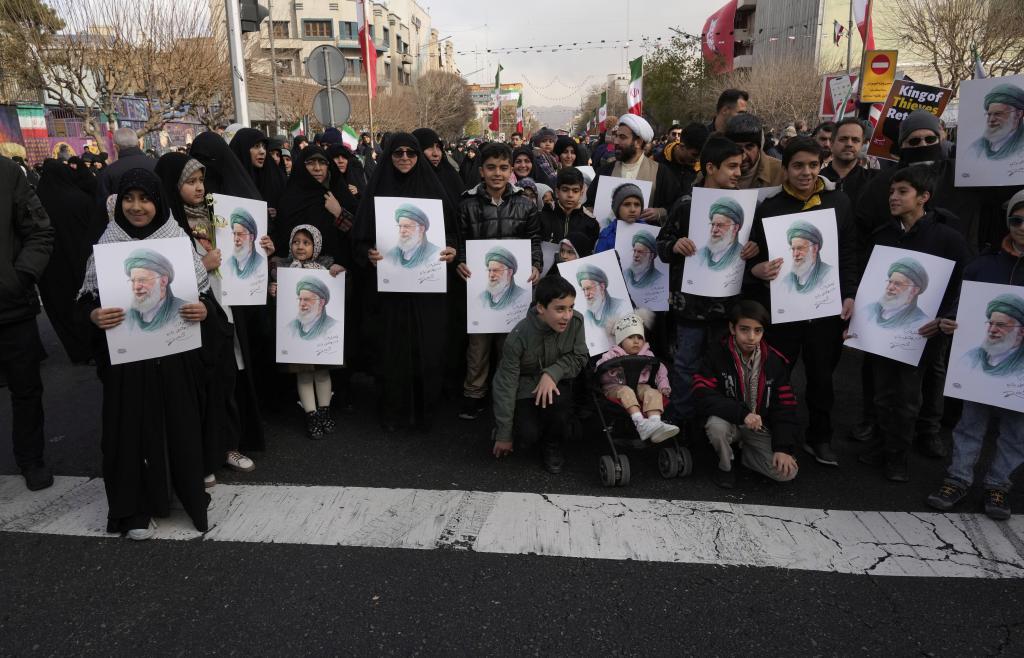 People hold posters of the Iranian Supreme Leader Ayatollah Ali Khamenei