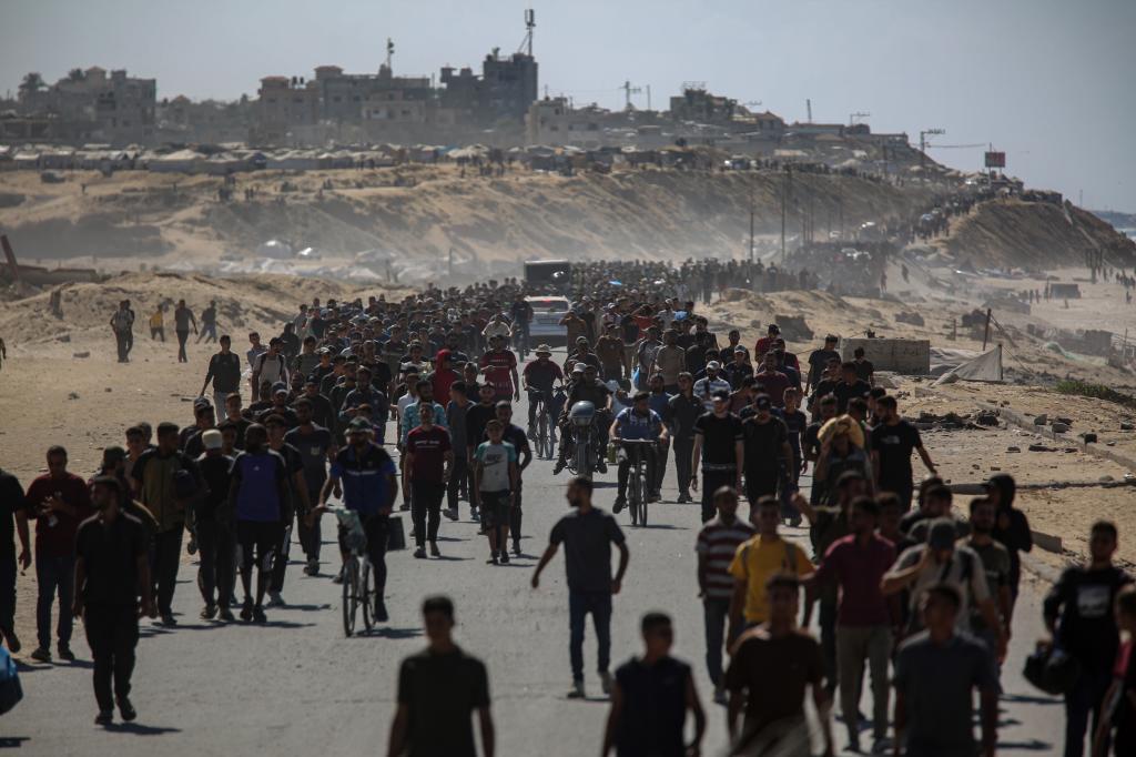 Palestinians make their way along Al-Rashid road toward Gaza City from Nuseirat in the central Gaza Strip