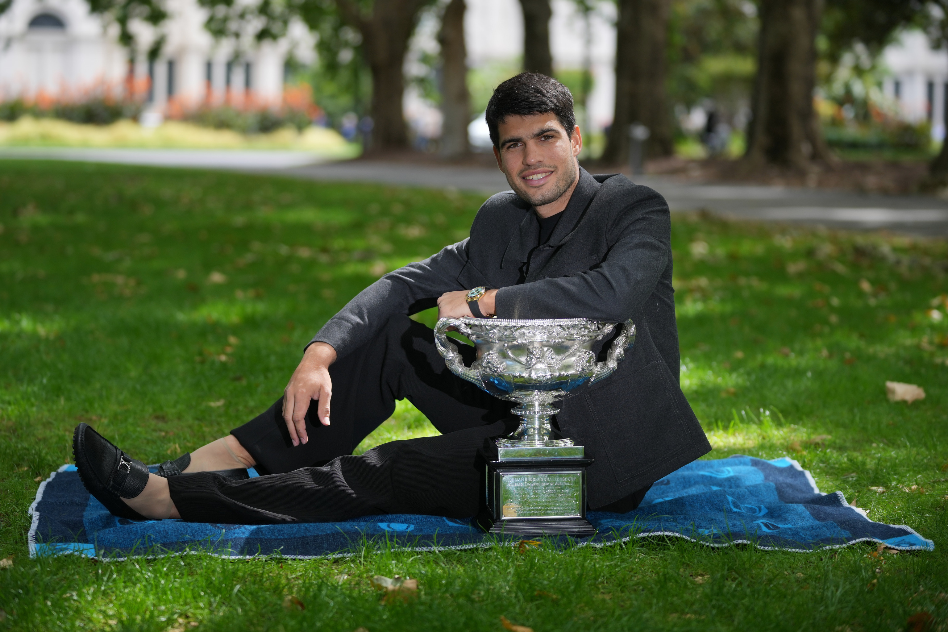 Carlos Alcaraz of Spain holds the Norman Brookes Challenge Cup