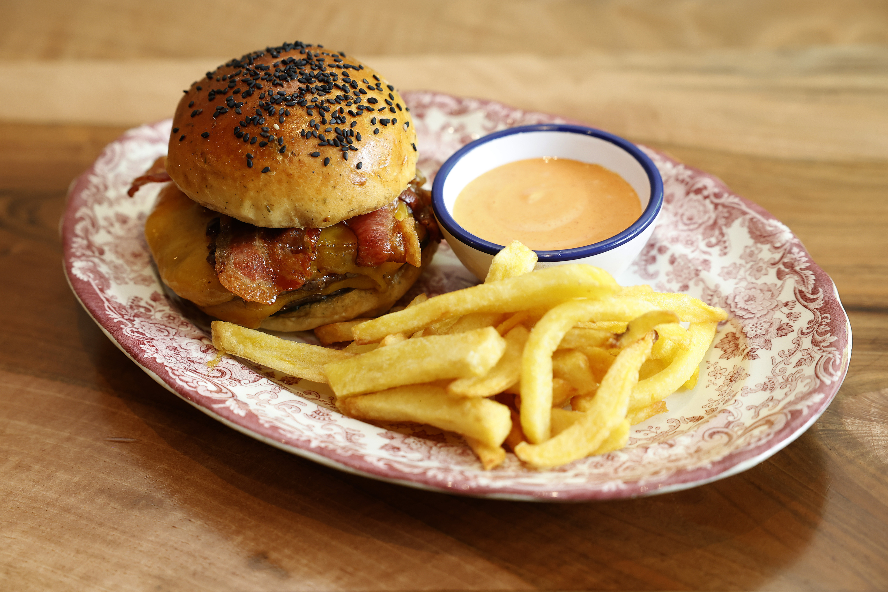 A hamburger with fries.
