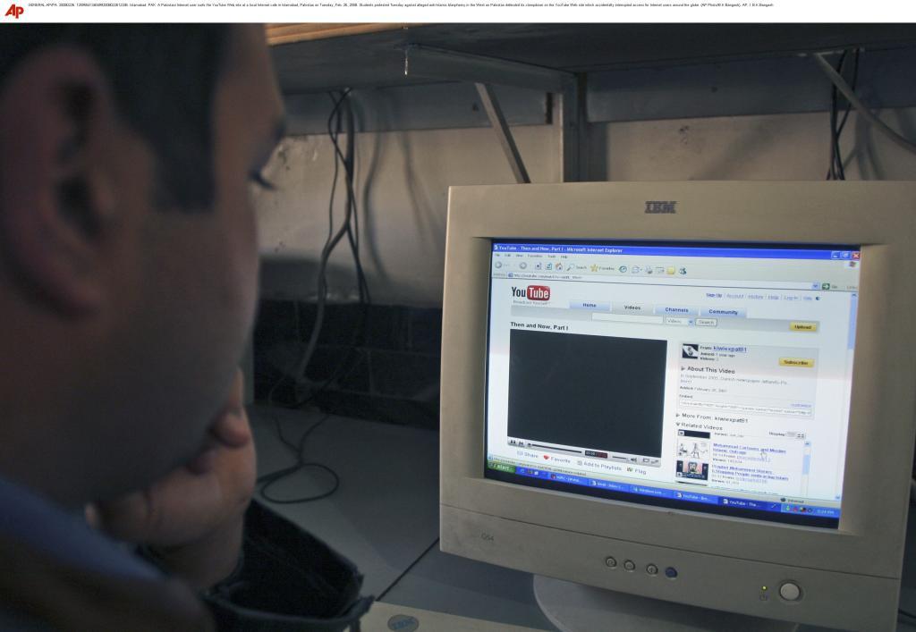 A Pakistani Internet user surfs the YouTube Web site at a local Internet cafe in Islamabad