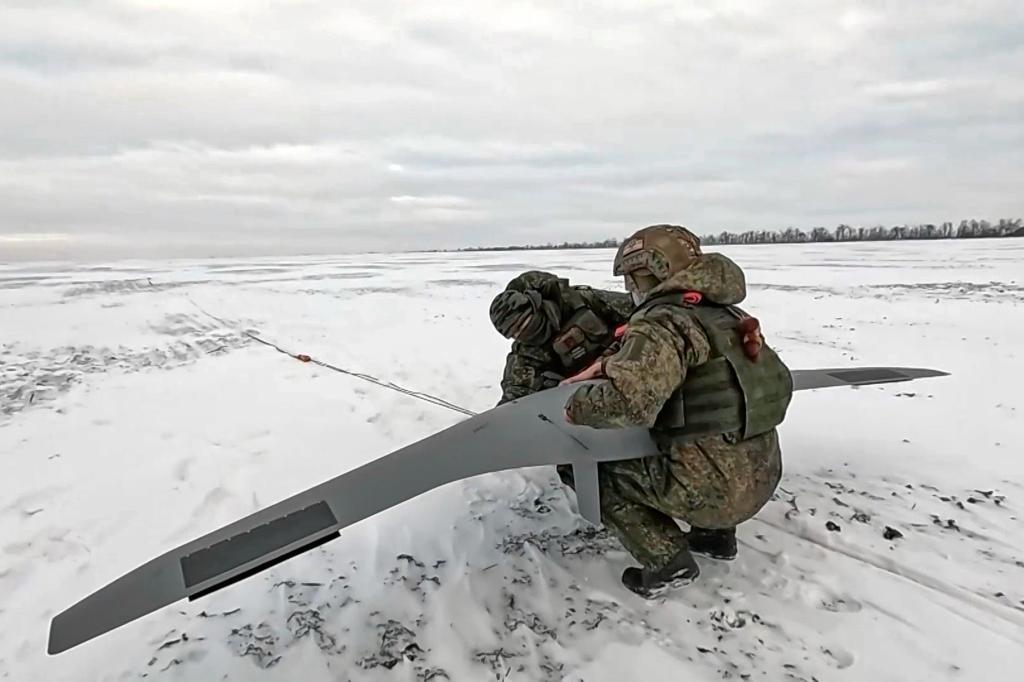 Russian soldiers prepare to launch a drone for an action in an undisclosed location in Ukraine