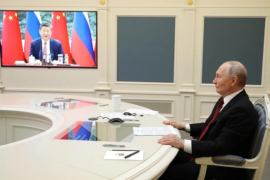 Vladimir Putin chats via video conference with Xi Jinping.