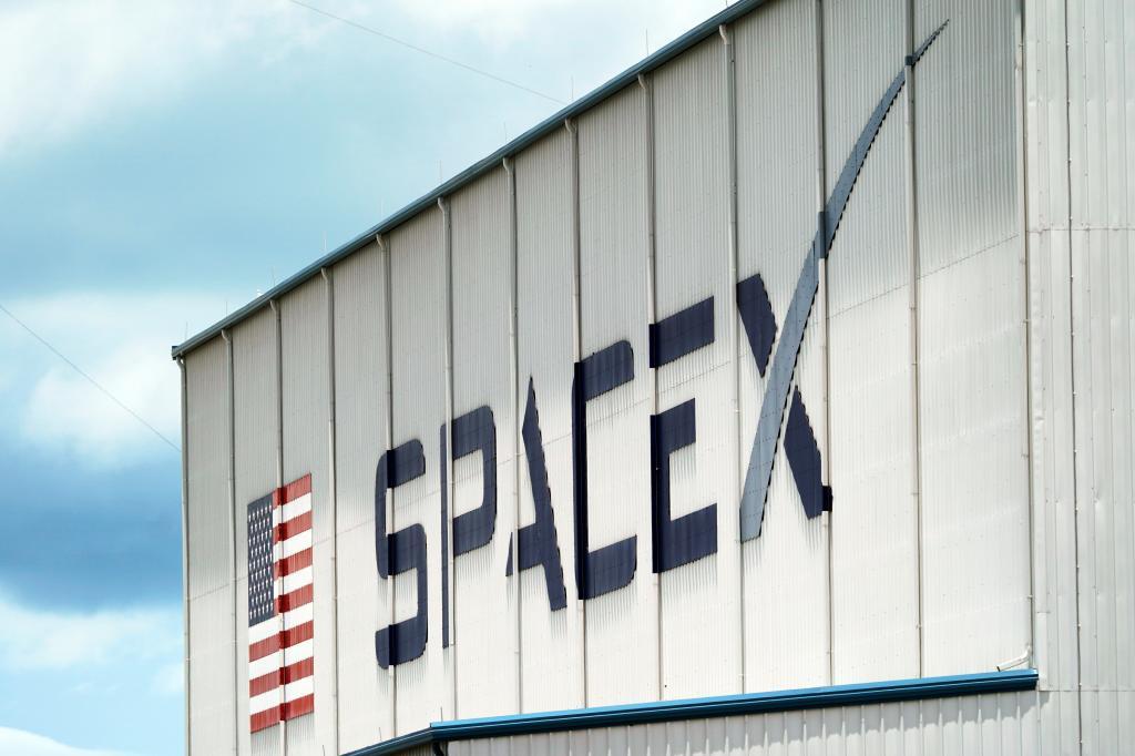 A SpaceX logo is displayed on a building.