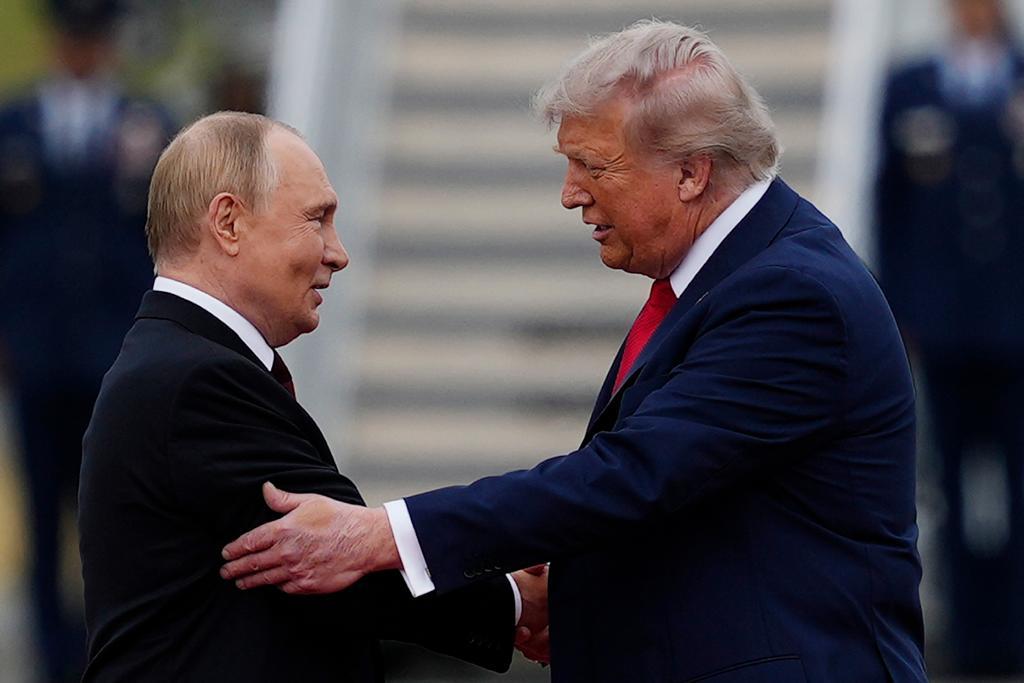 U.S. President Donald Trump greets Russian President Vladimir Putin