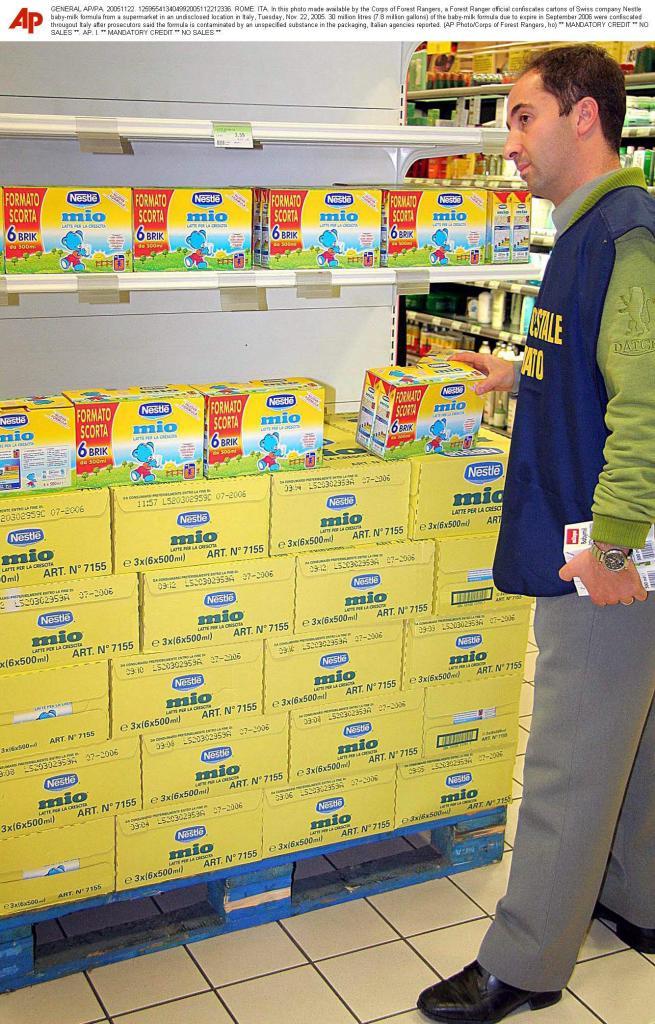 Forest Ranger official confiscates cartons of Swiss company Nestle baby-milk formula from a supermarket in an undisclosed location in Italy in 2005.