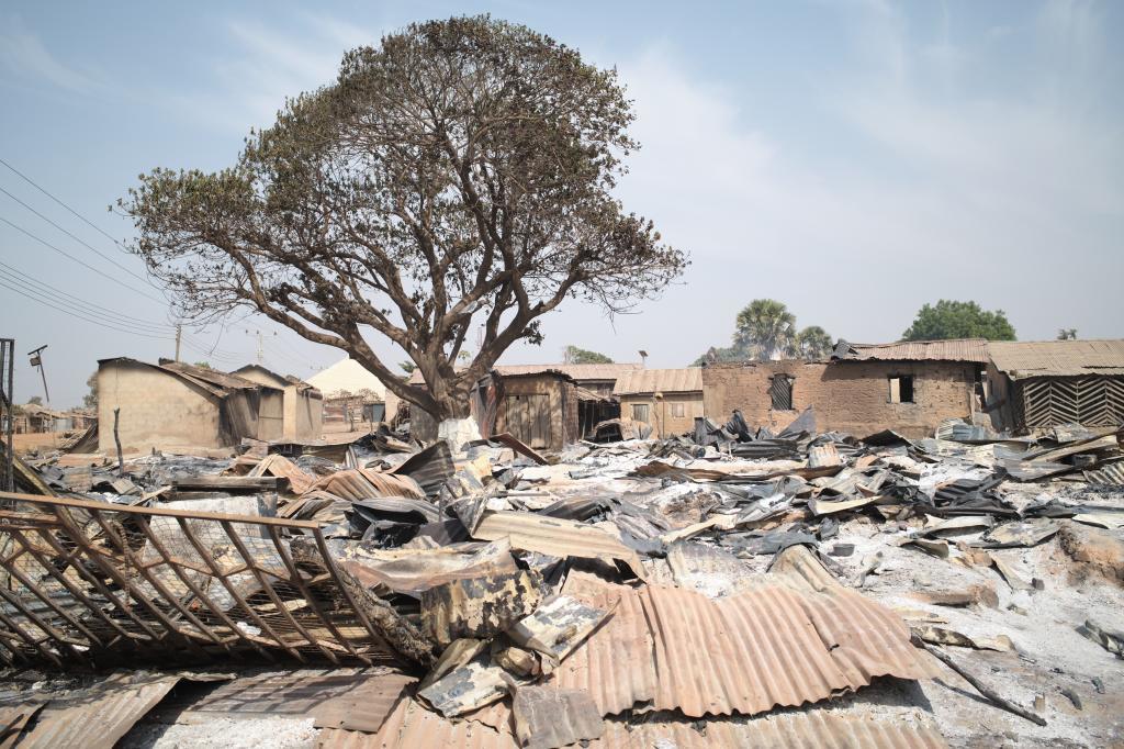 Burned homes sit days after an attack in the village of Woro, Nigeria