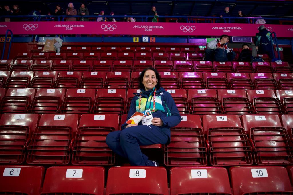 Cristina Romagnoli, a volunteer poses at the venue that hosts the short track speedskating