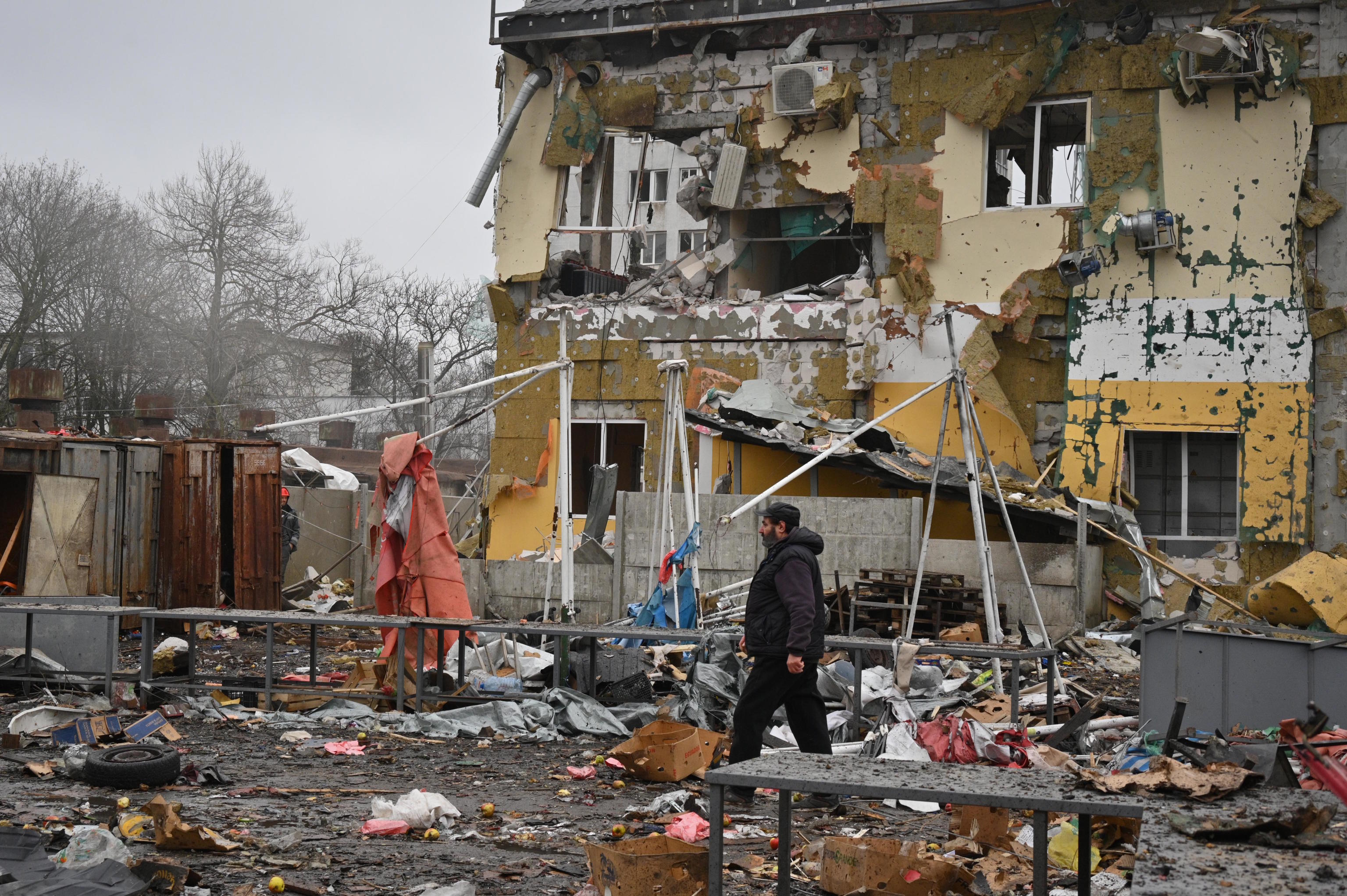 A man walks at a ruined city market following a Russia's attack in Odesa.