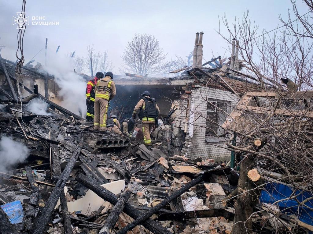Ukrainian Emergency Service, firefighters put out the fire in private houses following a Russian air attack in Sumy region