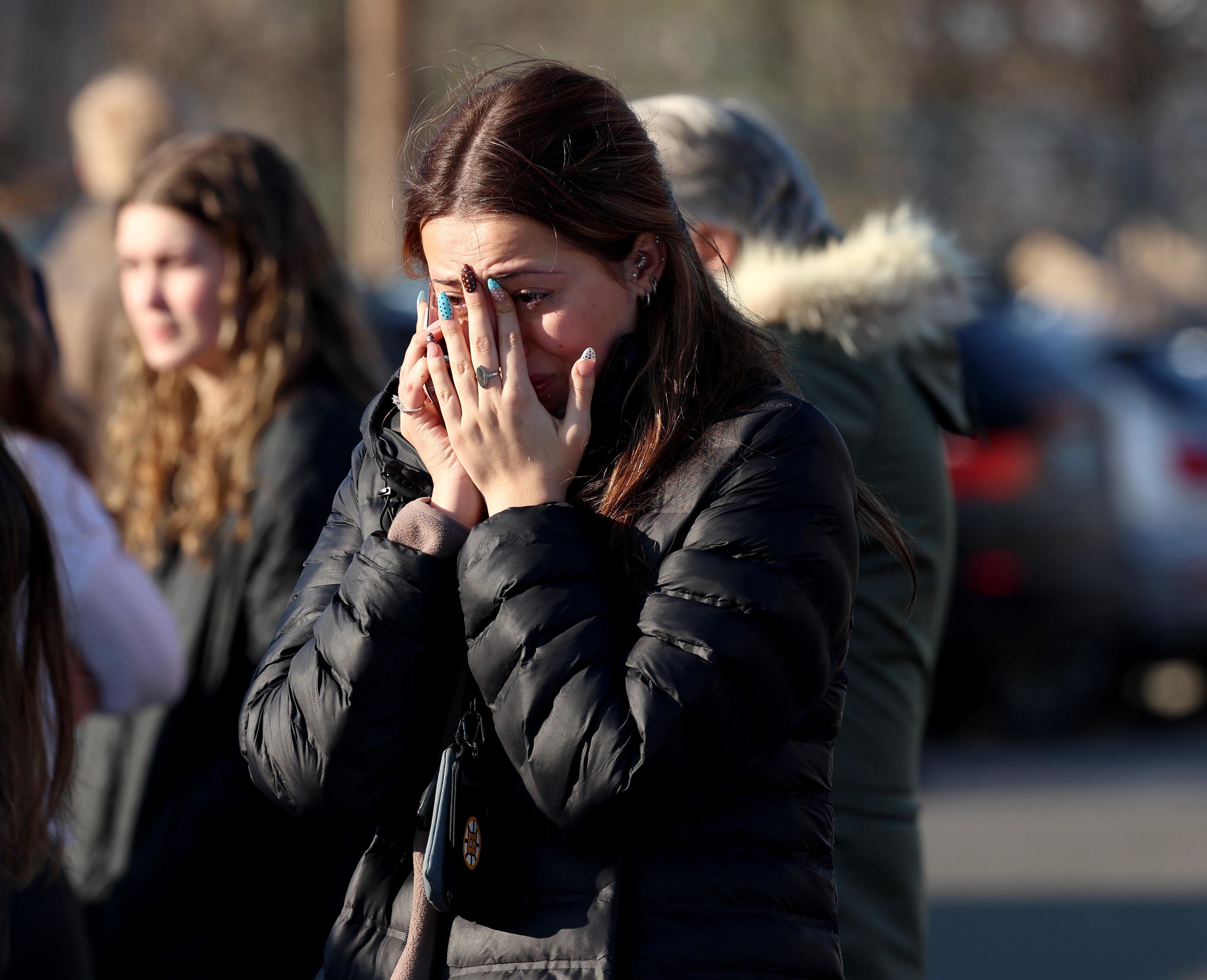 A woman grieves after a shooting at an ice rink.