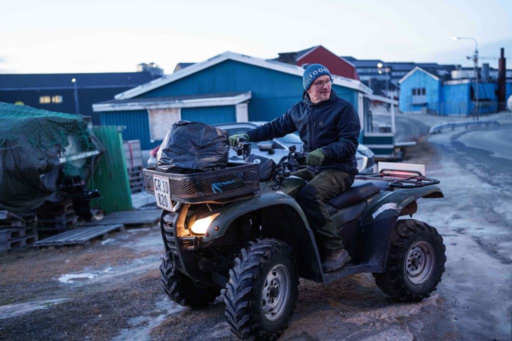 J�rgen Kristensen rides an all-terrain vehicle in Ilulissat, Greenland