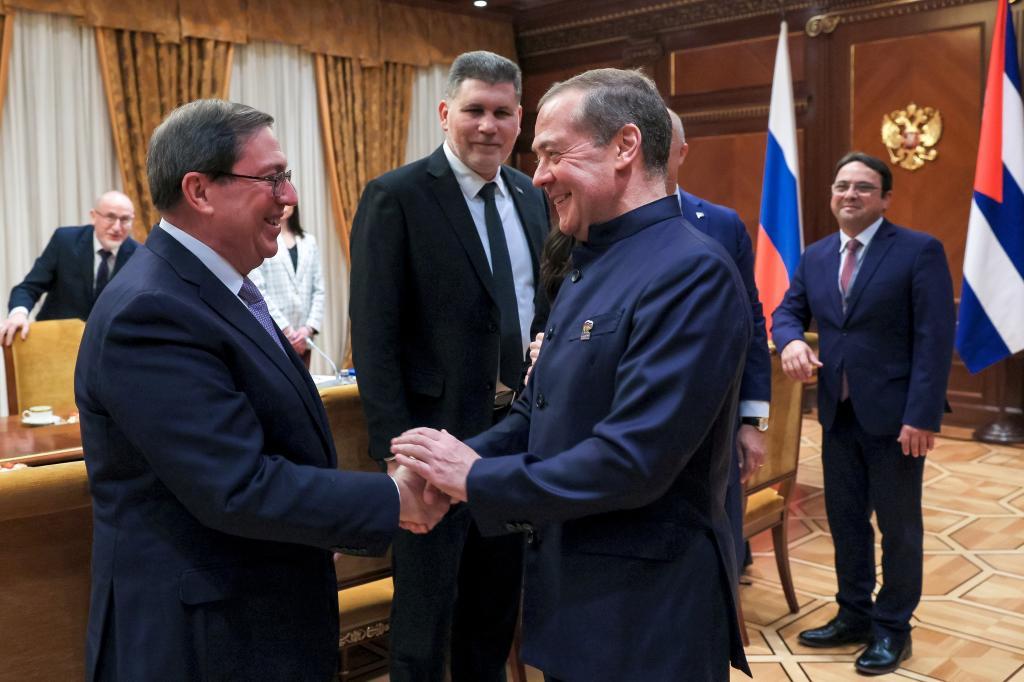 Cuban Foreign Minister Bruno Rodriguez, left, and Russian Security Council Deputy Chairman and the head of the United Russia party Dmitry Medvedev,